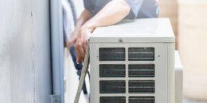 air conditioner compressor repairman washing dirty compartments